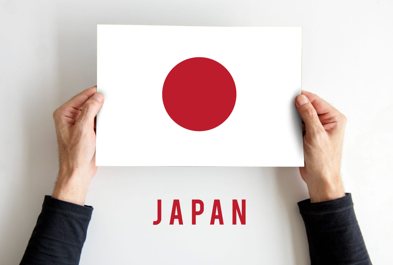 Flag of Japan held by a man